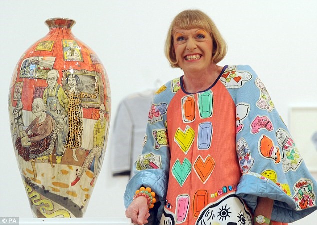 Grayson Perry crossdressed as his alterego Claire with one of his trademark Vase art pieces