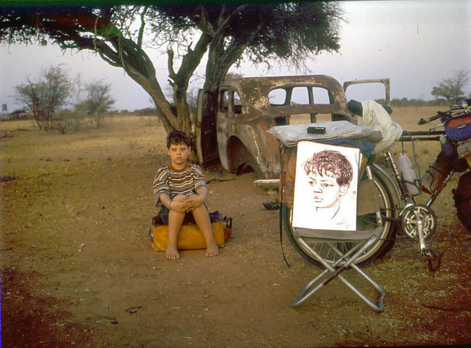 Vladislav Ketov doing a portrait painting job on the road to make some money